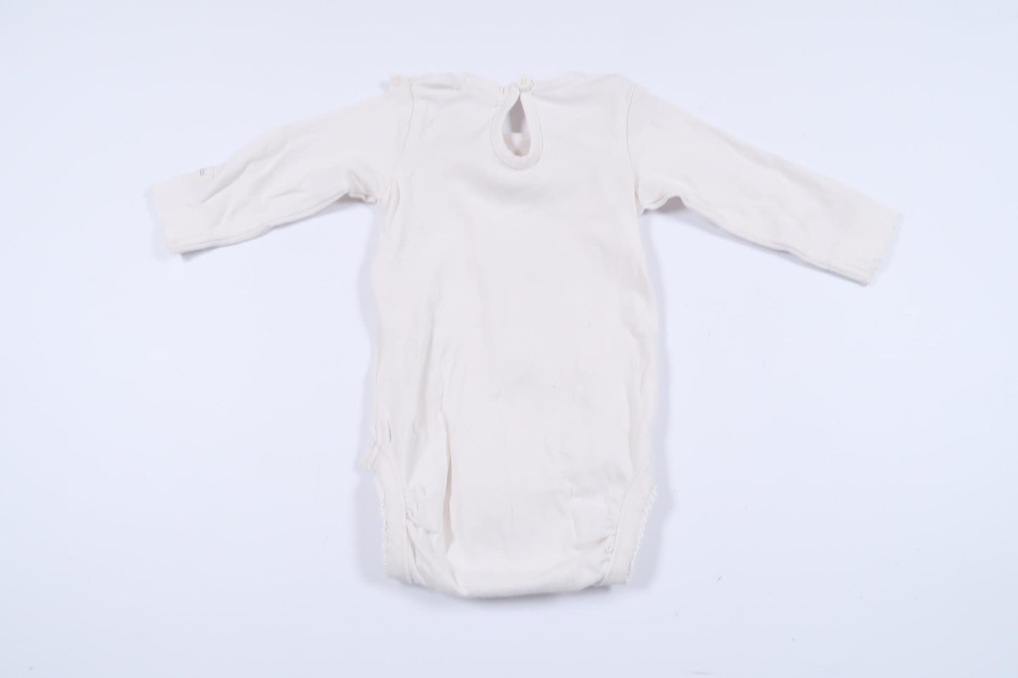 White long-sleeved bodysuit with lace detail from Newbie in size 56