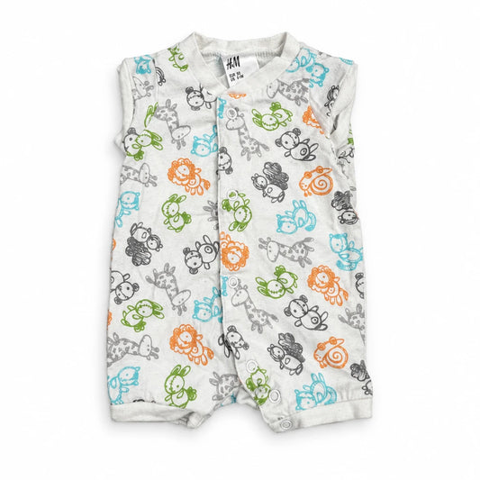Djurmönstrad onesie från H&M - Storlek 50 - Benvit